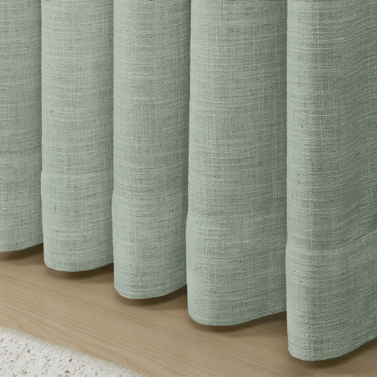 Pale Blue Aqua Liz linen curtains in a close room detail highlighting the linen texture and colour