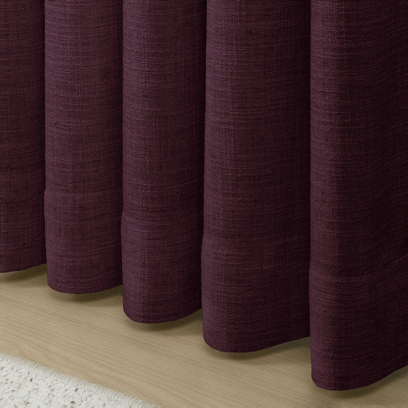 Plum Liz linen curtains showing the lower drape and pooling folds near the floor
