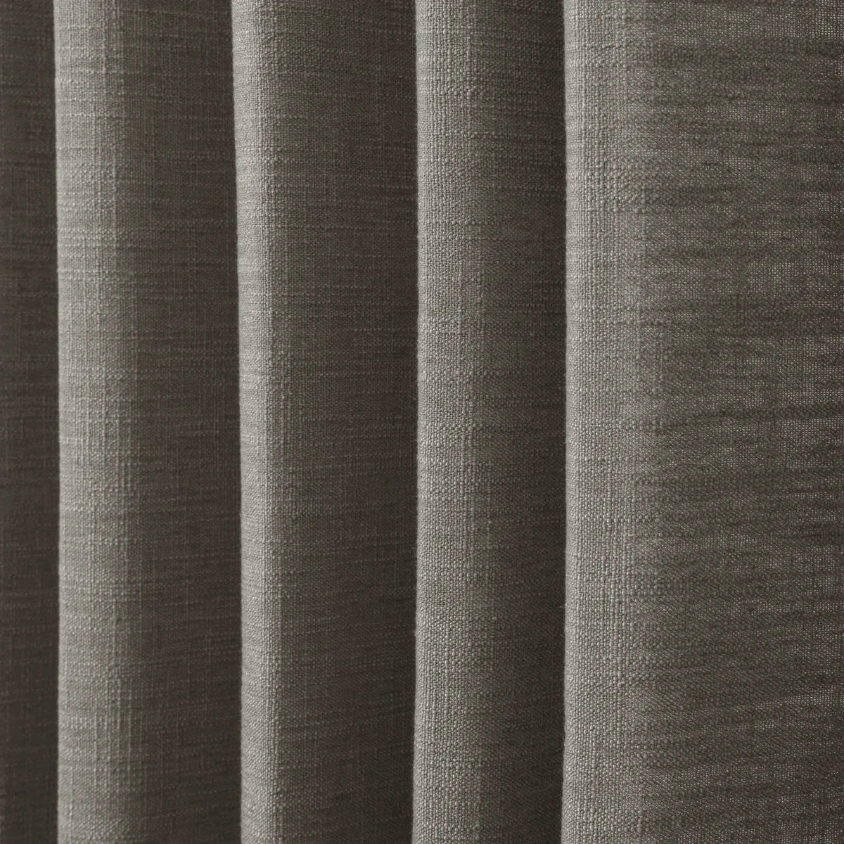 Sepia Ebony Liz linen curtains in a wider lifestyle scene with furnishings and softly flowing folds