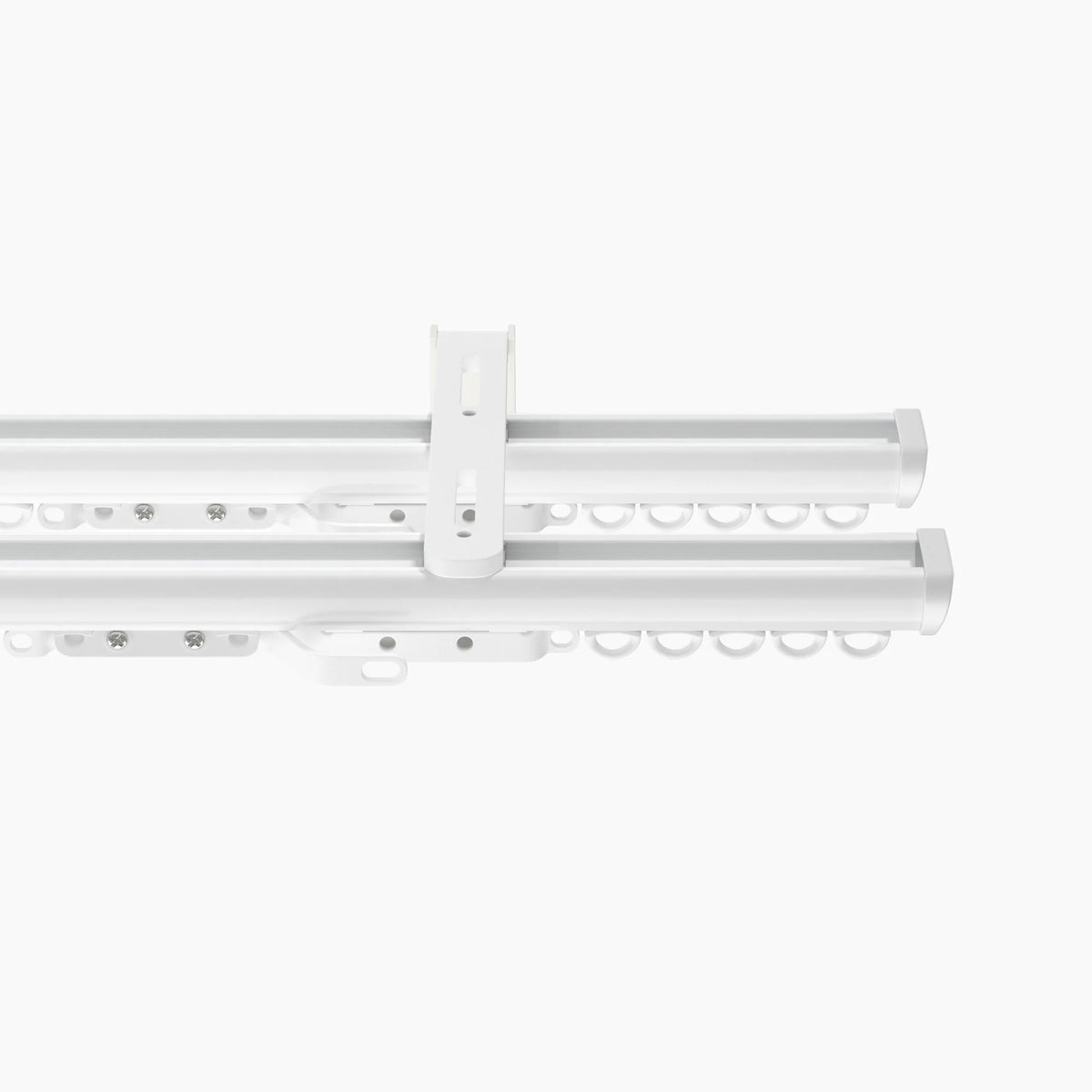 Product photograph of a modern white double curtain track system featuring a central ceiling mount bracket rows of D-shaped gliders and sleek end caps