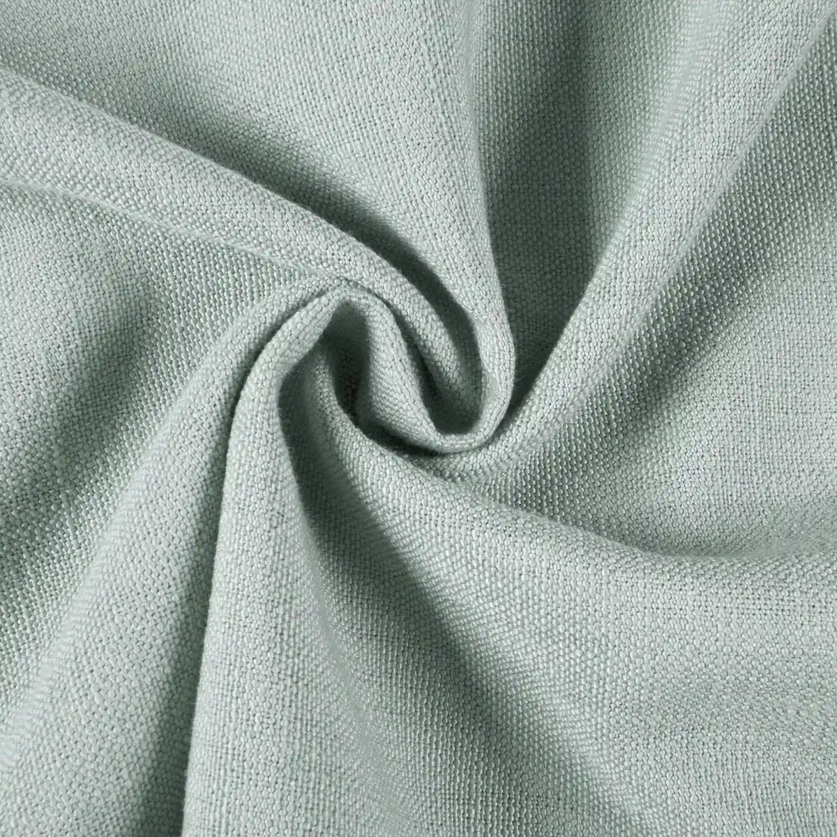 Photograph of mint green coarse woven fabric gently swirled into a soft spiral